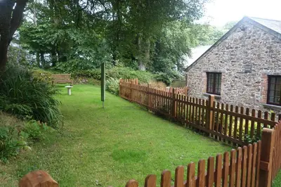 a wooden fence in front of a stone house at The Roundhouse in Launceston