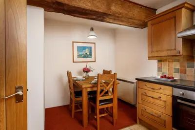 a kitchen with a table and chairs in a room at The Roundhouse in Launceston