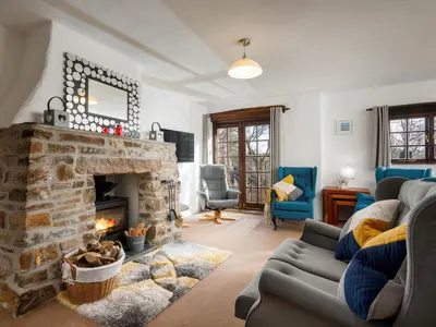 a living room with a couch and a fireplace at Beech Cottage in Launceston