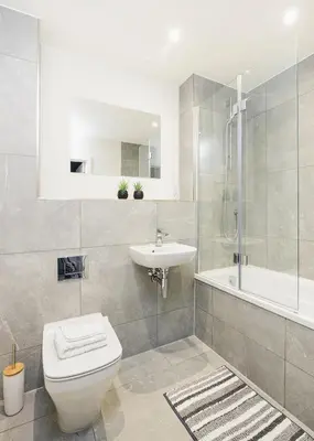 a bathroom with a toilet and a sink and a tub at Ocean-Walk Granny's Lane Perranporth in Perranporth