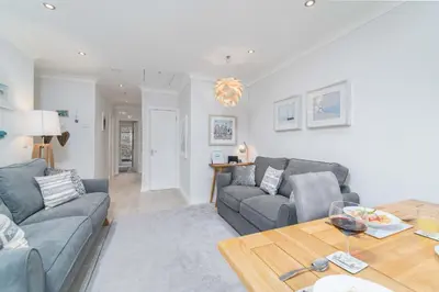 a living room with two couches and a table at Sea Shells in St Ives