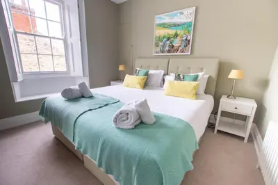 a bedroom with two beds with towels on them at Villa Louise in St Ives