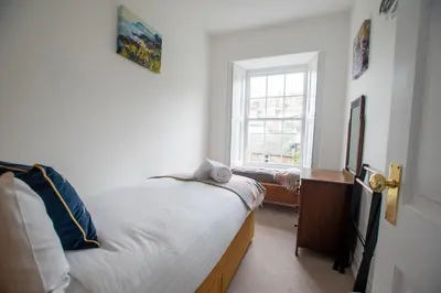 a bedroom with a bed and a window at Villa Louise in St Ives