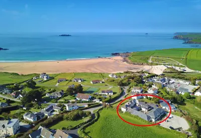 an aerial view of a house with a red circle at BY THE BEACH cottage, dogs welcome in St Merryn