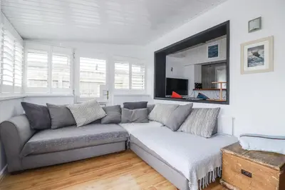 a living room with a couch and a window at The Three Tees in Newquay