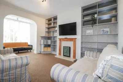 a living room with a couch and a fireplace at The Three Tees in Newquay