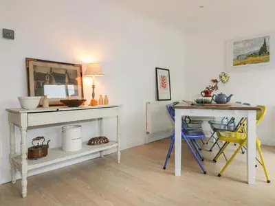 a room with a desk and a table with chairs at Eloen in Newquay