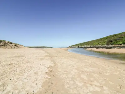 a view of a sandy beach next to the water at Eloen in Newquay