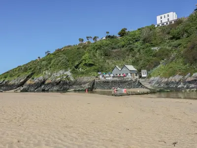 a house on top of a hill next to a beach at Eloen in Newquay