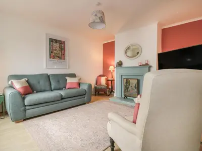 a living room with a couch and a fireplace at Eloen in Newquay