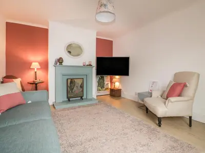 a living room with a couch and a fire place at Eloen in Newquay