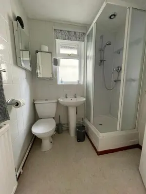 a bathroom with a toilet and a shower and a sink at Sunny detached bungalow, Nr Looe in Saint Keyne