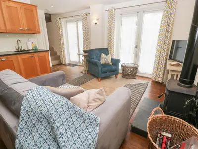 a living room with a couch and a stove at No 1 The Hinges in Newquay