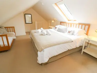 a attic bedroom with a bed and a window at No 1 The Hinges in Newquay