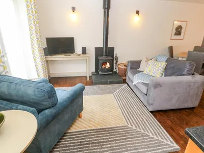 a living room with two couches and a fireplace at No 1 The Hinges in Newquay