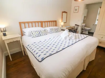 a bedroom with a large bed with two towels on it at No 3 The Hinges in Newquay