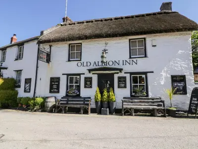 an oldaiden inn with two benches in front of it at No 3 The Hinges in Newquay