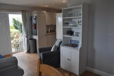 a living room with a couch and a chair at Morley's in Ponsanooth