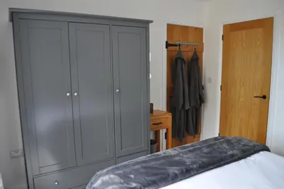 a bedroom with a large gray cabinet and a closet at Morley's in Ponsanooth