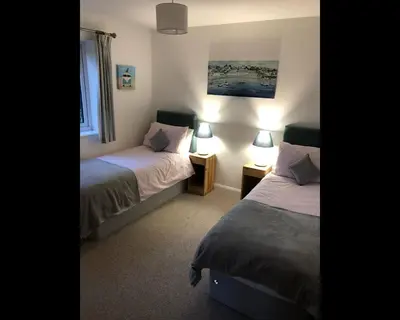 a hotel room with two beds and a window at Morley's in Ponsanooth