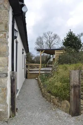 a building with a pathway next to a fence at Morley's in Ponsanooth
