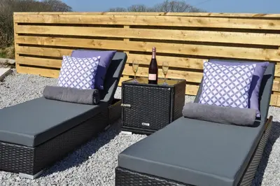 two chairs and a bottle of wine on a patio at Morley's in Ponsanooth