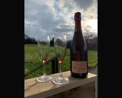 two wine glasses sitting next to a bottle of wine at Morley's in Ponsanooth