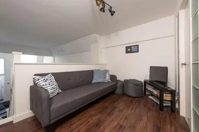 a living room with a couch and a tv at Mr Blue Sky in St Ives