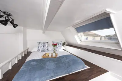 a small bedroom with a bed and a window at Mr Blue Sky in St Ives