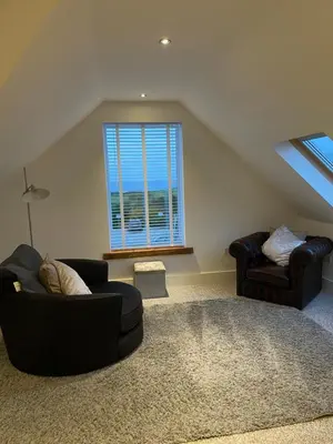 a living room with two couches and a window at The Town House - Newquay in Newquay