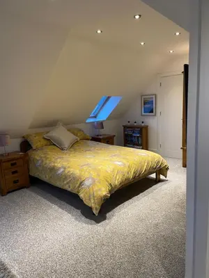 a bedroom with a bed with a yellow comforter at The Town House - Newquay in Newquay