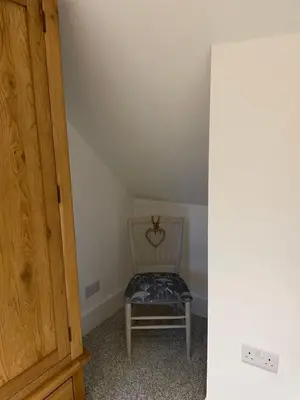 a chair sitting in a room next to a door at The Town House - Newquay in Newquay