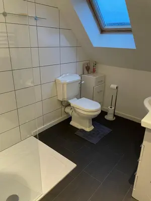 a bathroom with a toilet and a glass shower at The Town House - Newquay in Newquay