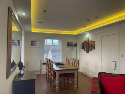 a dining room with a table and chairs at The Town House - Newquay in Newquay