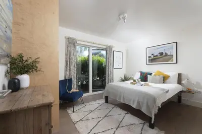 a bedroom with a bed and a window at 6 The Dunes At Upton Towans - Short walk to the beach - Hot Tub - Free Wi-Fi in Hayle