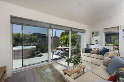 a living room with a large sliding glass door at 6 The Dunes At Upton Towans - Short walk to the beach - Hot Tub - Free Wi-Fi in Hayle