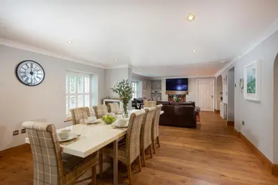 a dining room and living room with a table and chairs at 3 The Manor - Opposite a golf course - Pet friendly - Wi-Fi in Uny Lelant