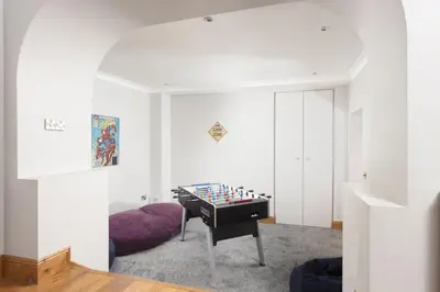 a living room with a foosball table in the corner at 3 The Manor - Opposite a golf course - Pet friendly - Wi-Fi in Uny Lelant