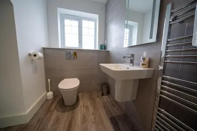 a bathroom with a sink and a toilet and a mirror at The Coffee Loft in Padstow