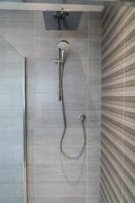 a shower with a shower head in a bathroom at The Coffee Loft in Padstow