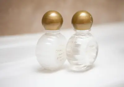 two glass vases with gold tops sitting next to each other at Griffin Inn in Newquay