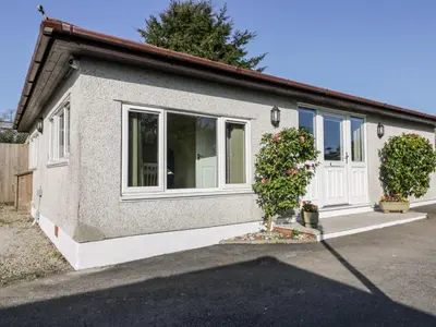a house with a white door and a plant at Lower Brambleside in Truro