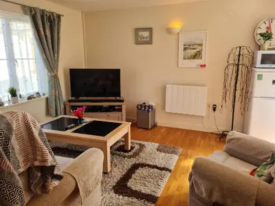 a living room with a tv and a coffee table at 2-Bed Cottage Sleeps 5 Pets Ok Close to Coast in Davidstow