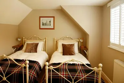 two beds in a room with a attic at The Dog House, Penryn in Penryn