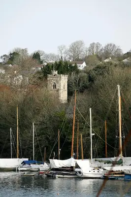 a group of boats docked in a body of water at The Dog House, Penryn in Penryn