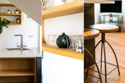 a kitchen with a sink and a bar stool at Manderley Penthouse in St Ives