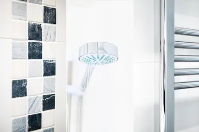 a shower in a bathroom with a shower head at Harbour Vista in St Ives