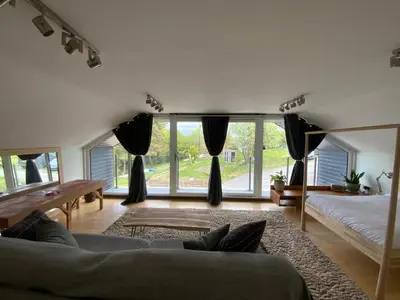 a living room with a couch and a large window at Little Chi in Truro