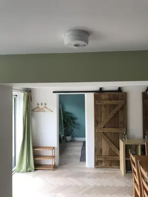 a sliding barn door in a living room at Little Chi in Truro