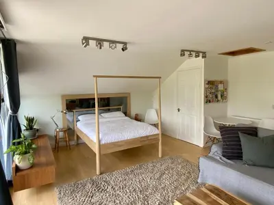 a bedroom with a bed with a metal frame at Little Chi in Truro